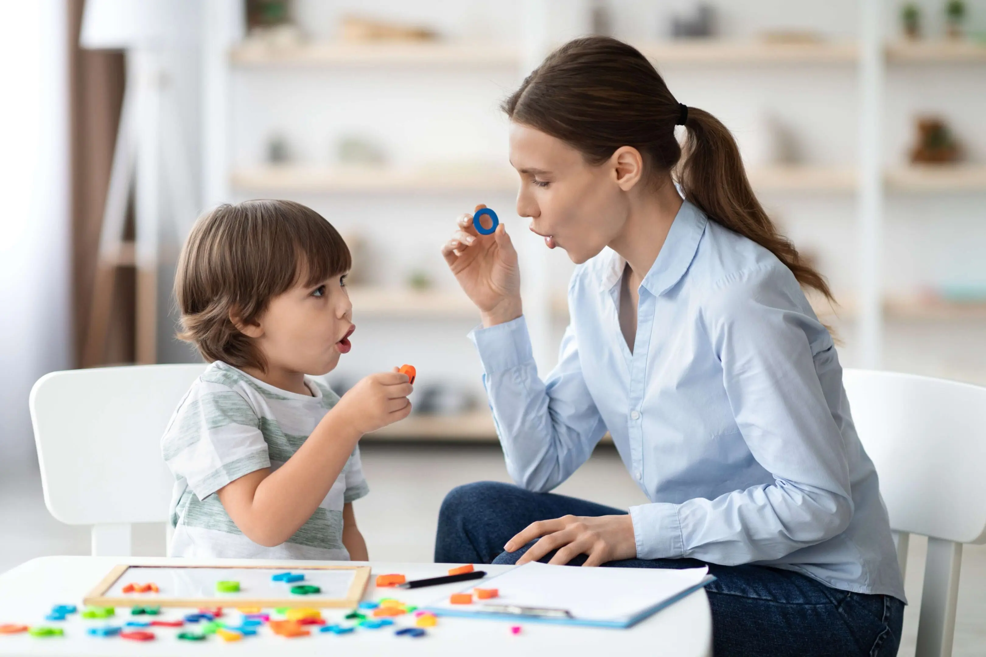 A mother teaching her child with colorful educational toys.